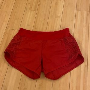 red lululemon running shorts with side ruffle detail